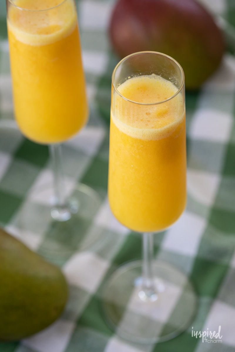 two Mango Mimosas in champagne glasses.