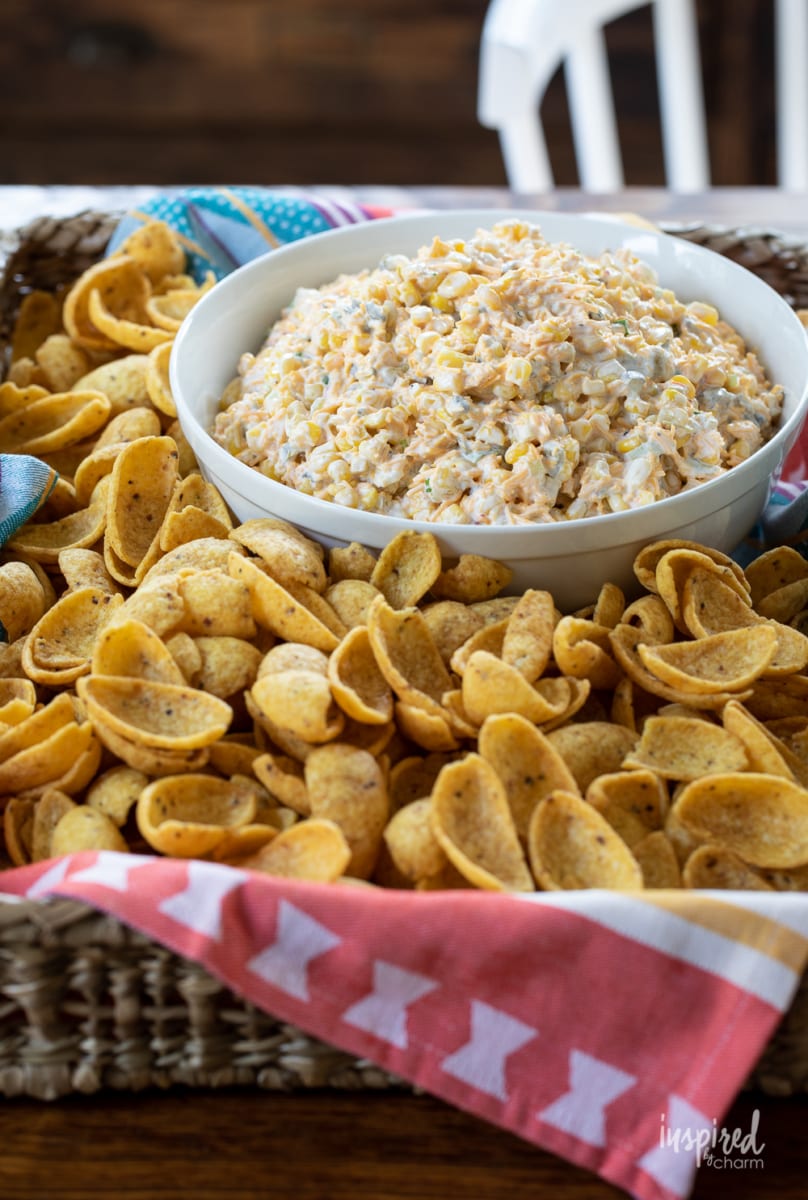 crack corn dip in bowl with chips.
