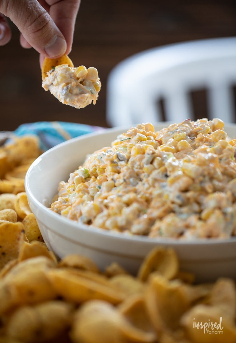 dipping into corn dip with chip.