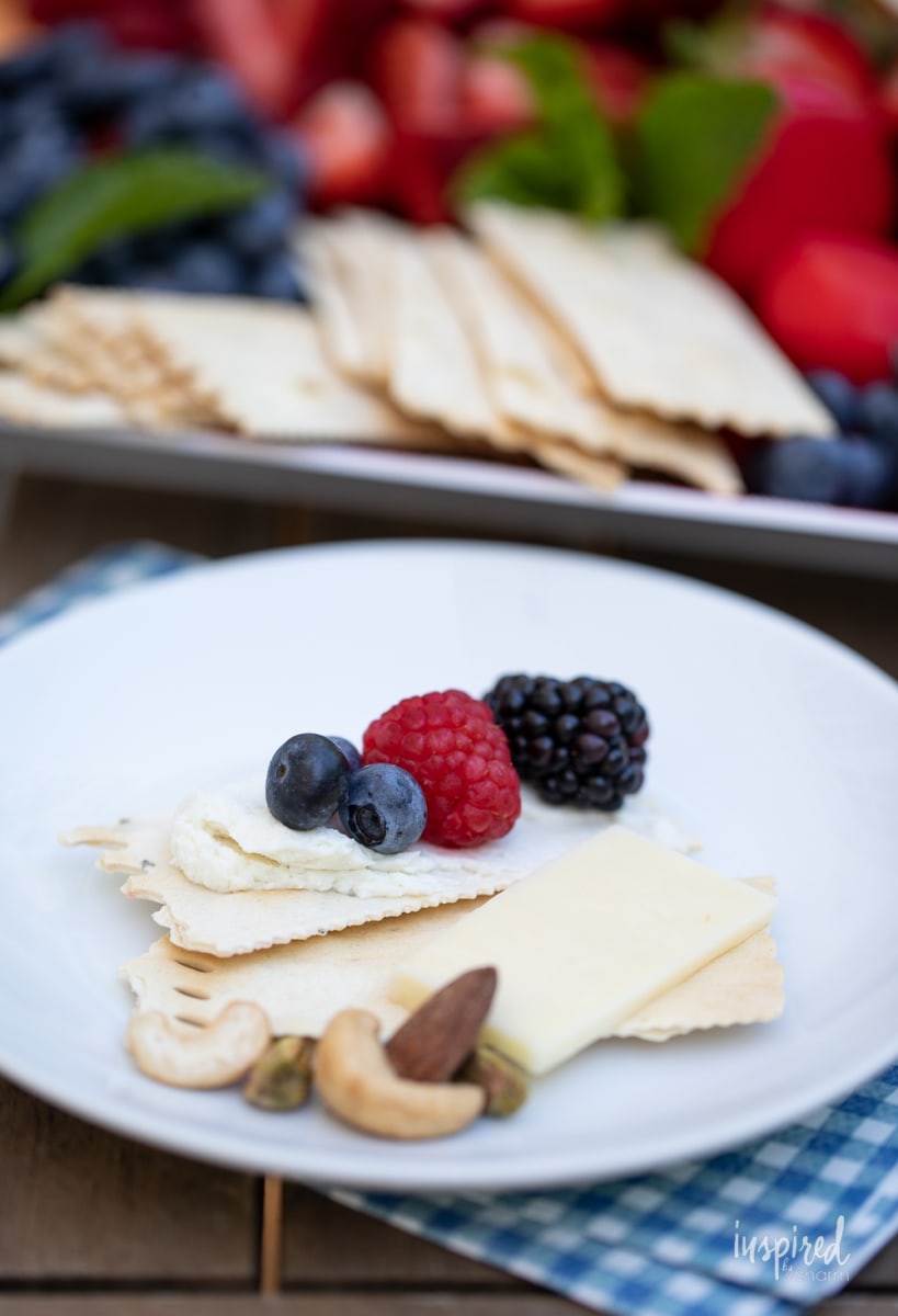 whipped honey goat cheese spread on cracker with berries.