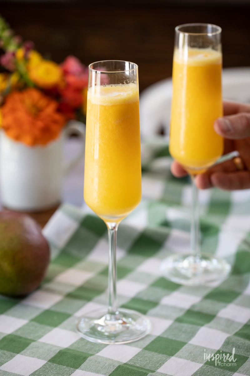 two Mango Mimosas in champagne glasses.