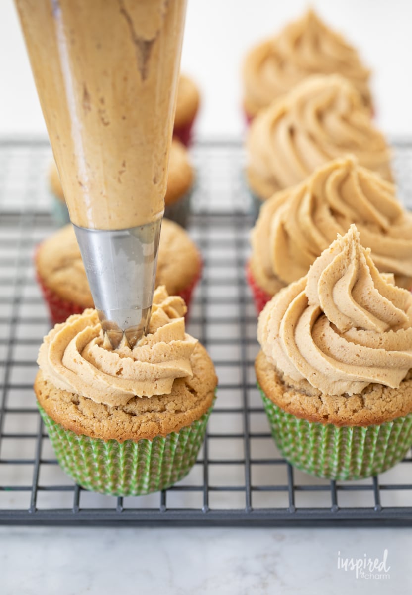 piping peanut butter frosting.