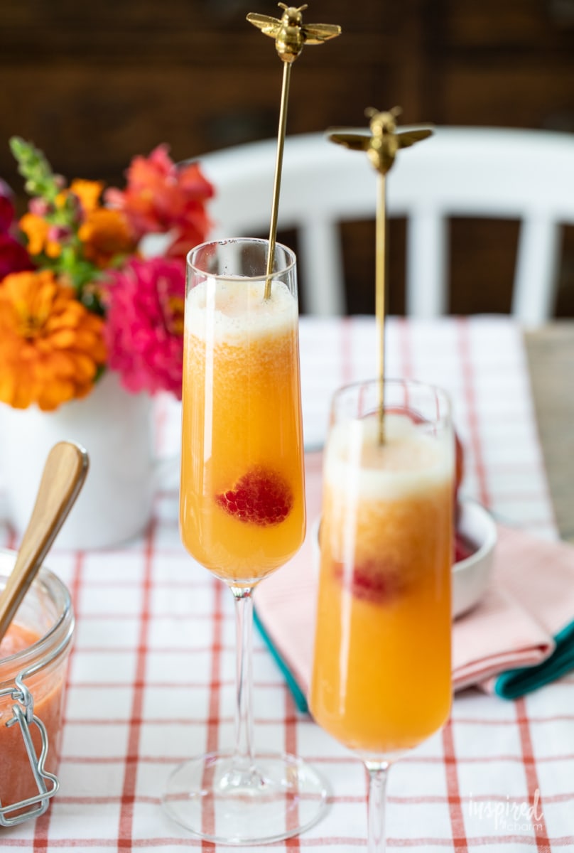 Raspberry Peach Bellinis in glasses on table