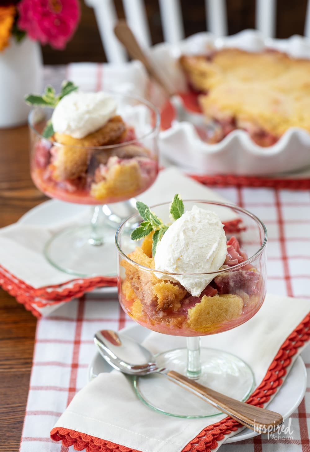 rhubarb cobbler in dishes on plates with napkins.