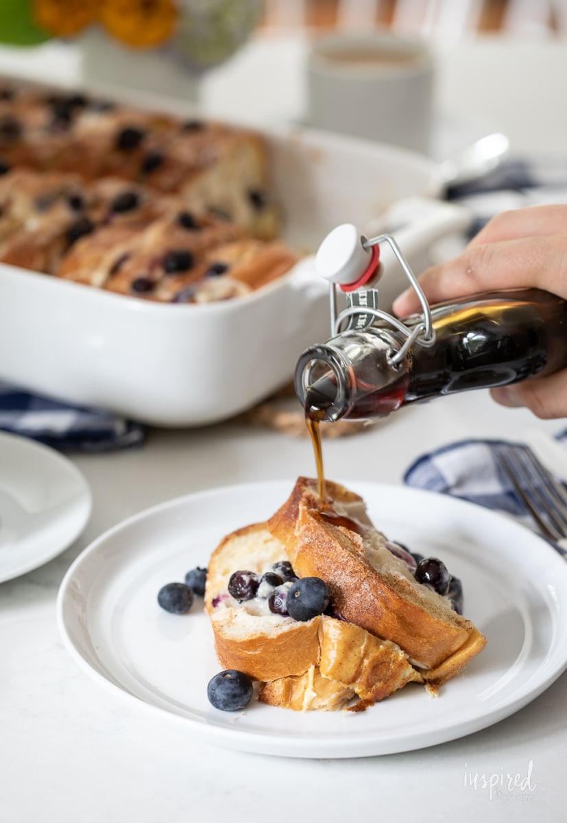 adding syrup to Blueberry French Toast Casserole.