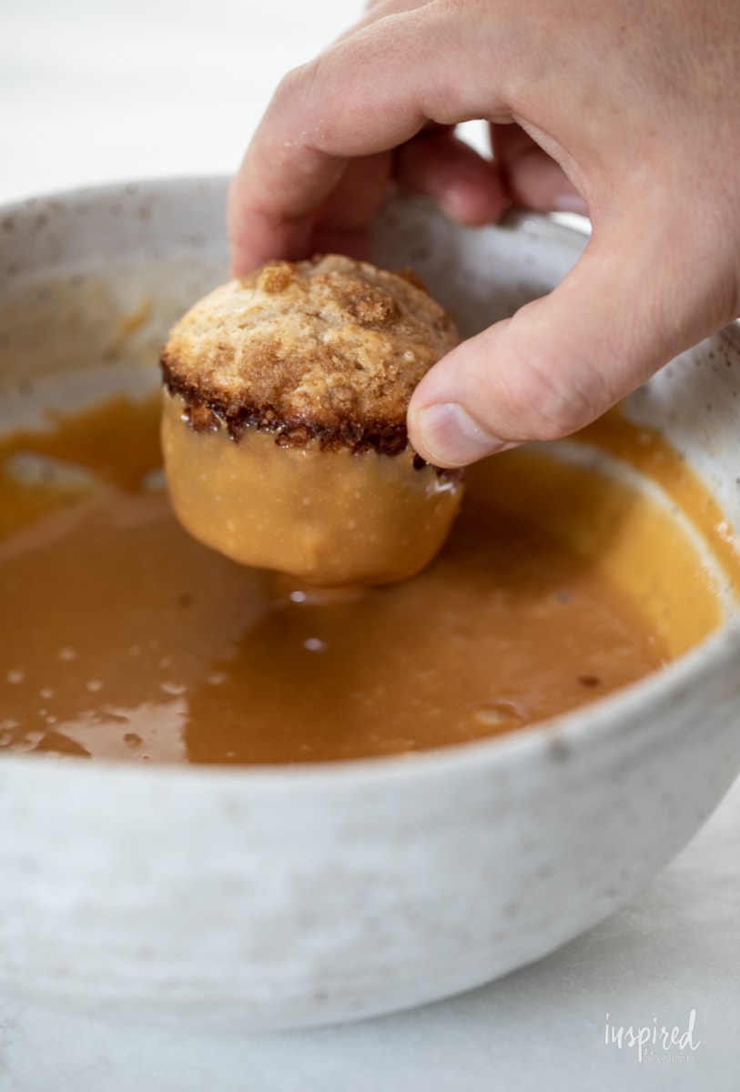 dipping muffin into caramel.