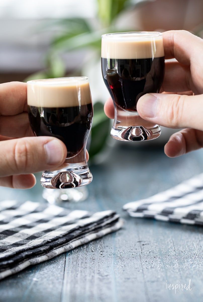 hands cheers baby Guinness shots.