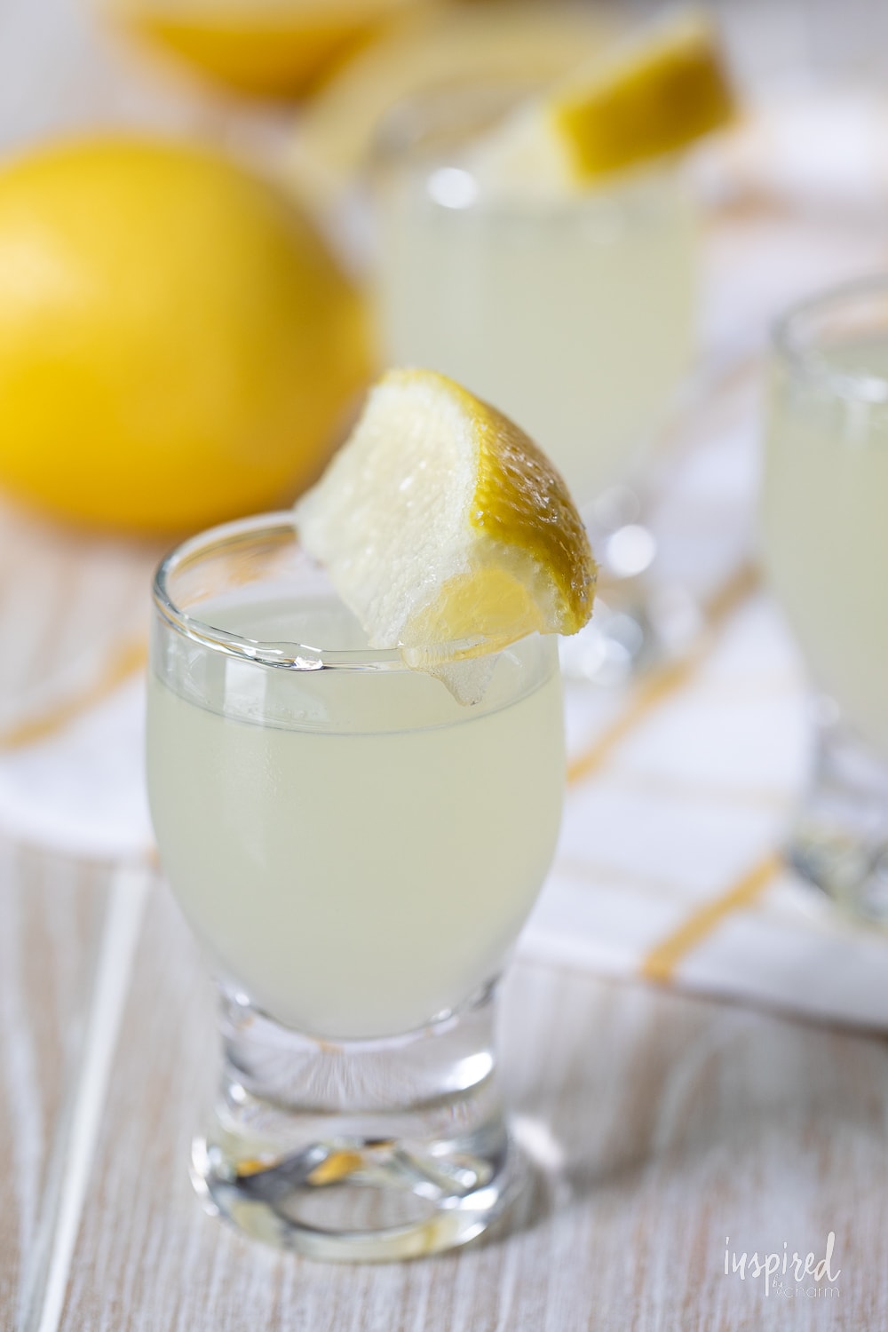 lemon drop shot in glass with lemon slice garnish.
