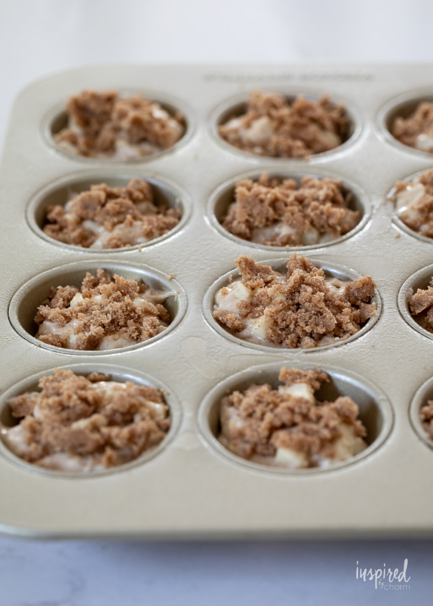 caramel apple muffins with cinnamon topping in pan. 