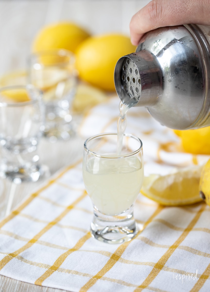 pouring lemon drop shot into glass.