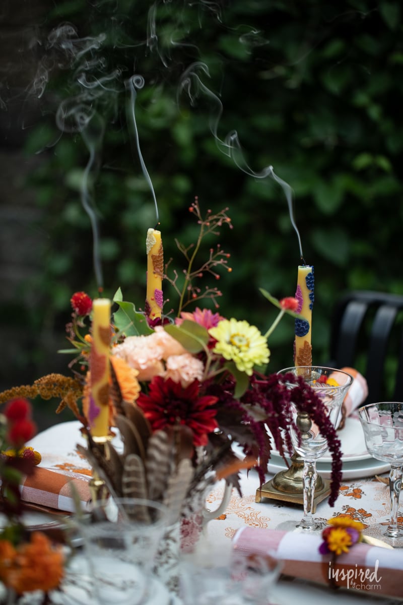 blown out candles on outdoor fall table.