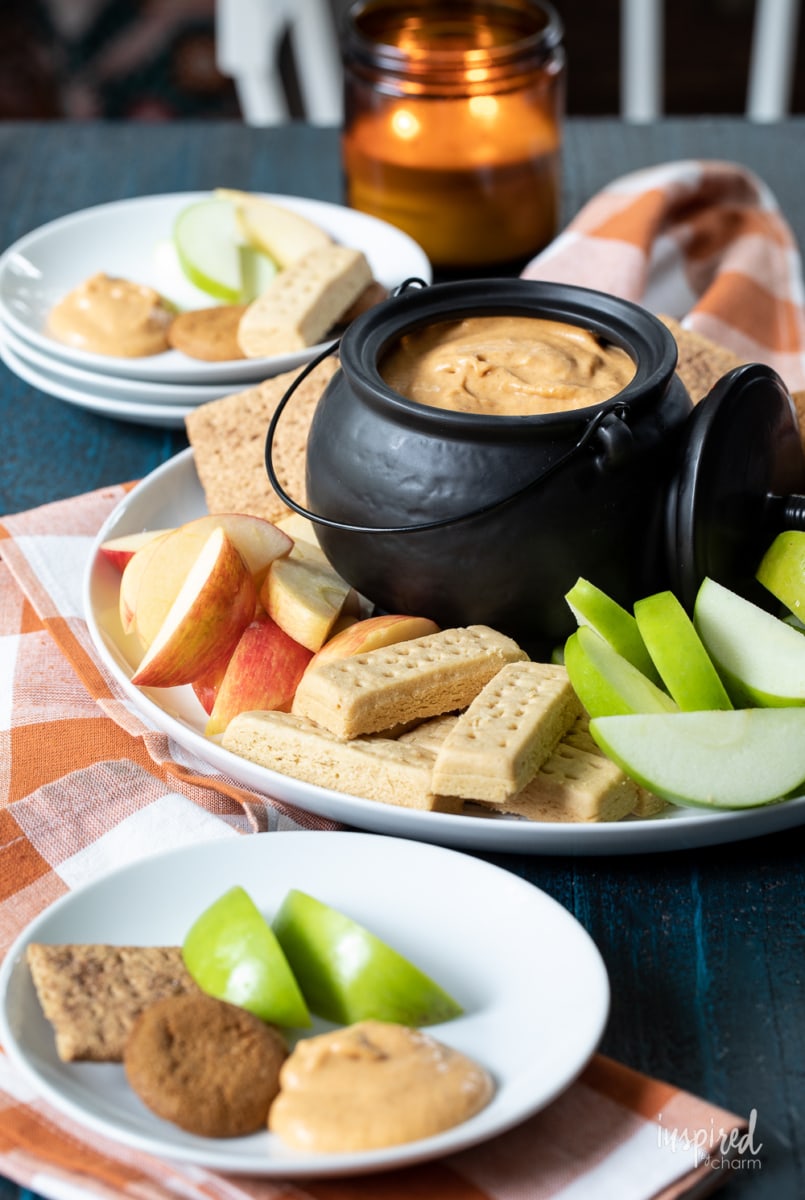 pumpkin dip in bowl with apples and cookies.