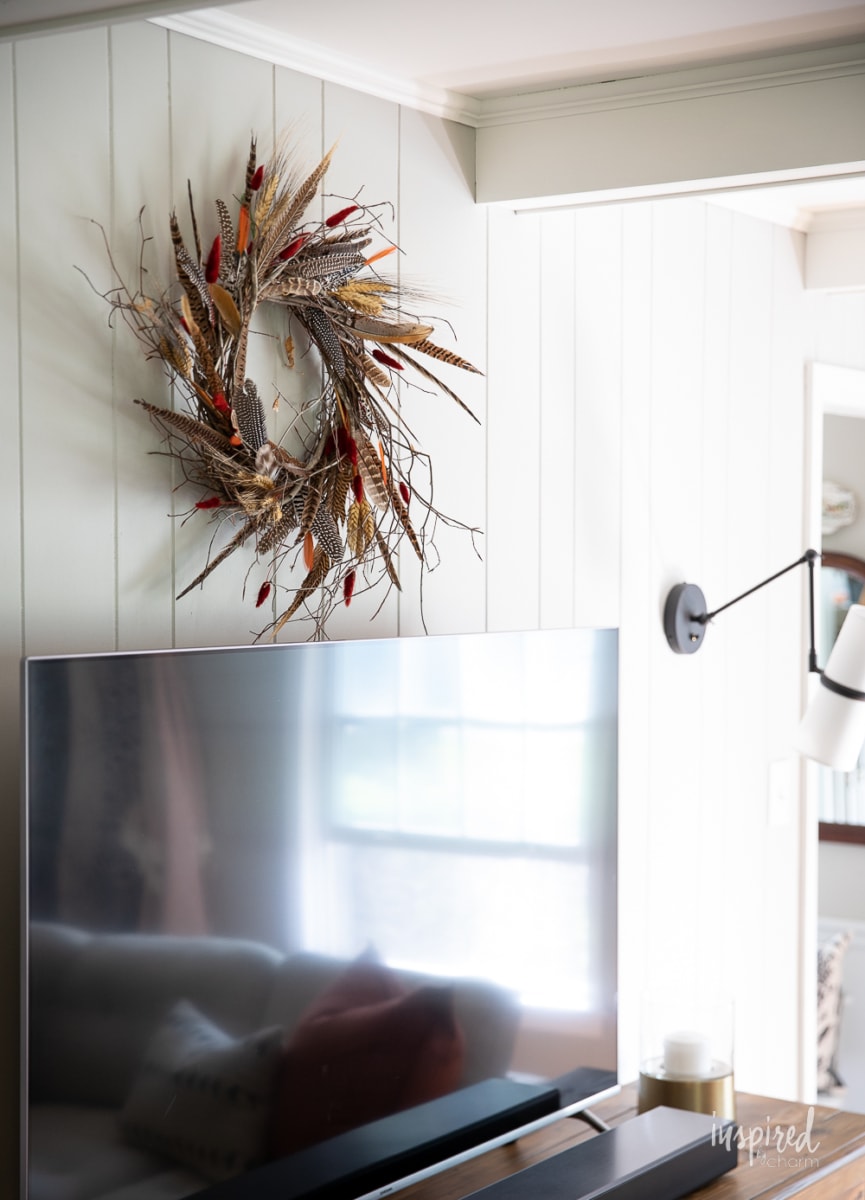 DIY Feather Wreath for Fall on wall above tv.