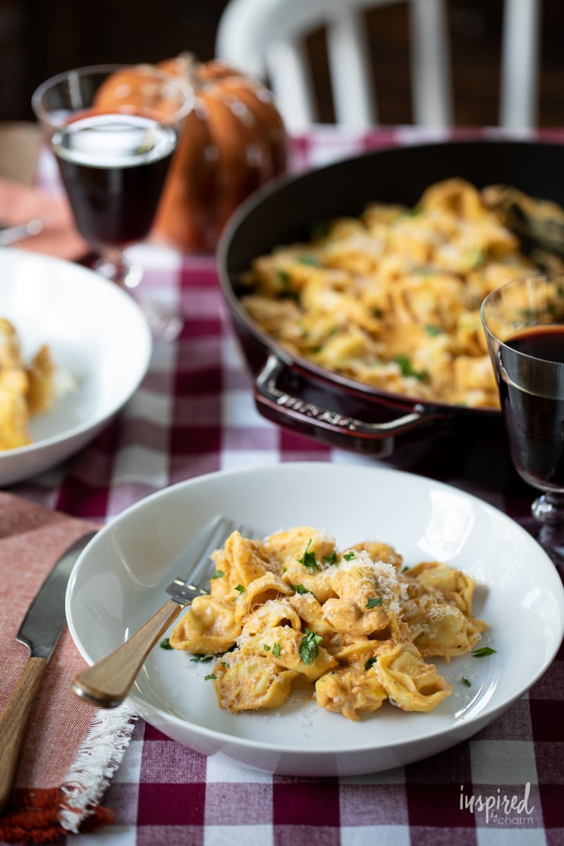 Creamy Pumpkin Tortellini serve on plates and in a pan.