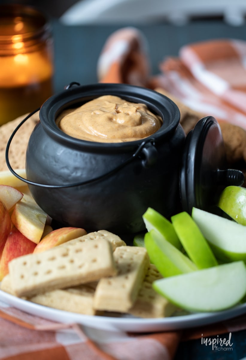 pumpkin dip in bowl with apples and cookies.
