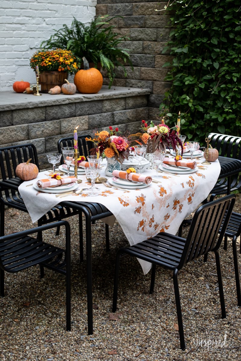 outdoor table at night styled for fall.
