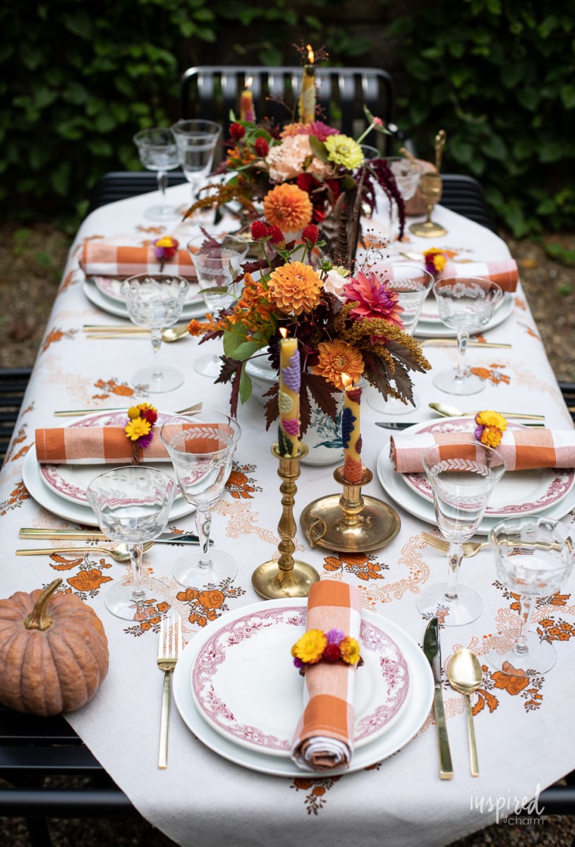 fall outdoor table setting with vintage tablecloth.