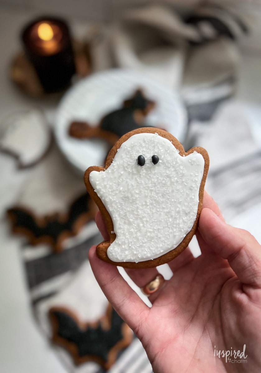 ghost halloween gingerbread cookie in hand.