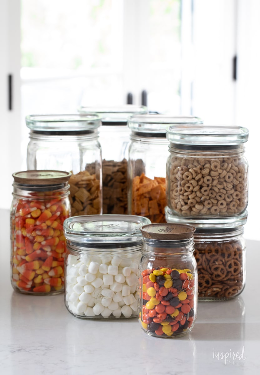 Sweet and Salty Fall Snack Mix ingredients in jars.