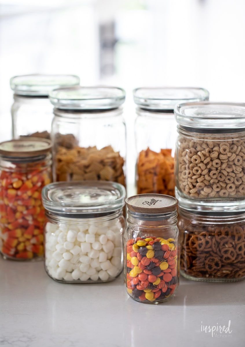 Sweet and Salty Fall Snack Mix ingredients in jars.