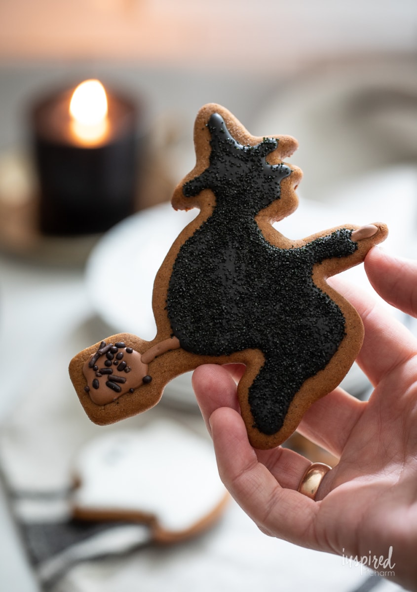 hand holding witch Gingerbread Halloween Cookies.