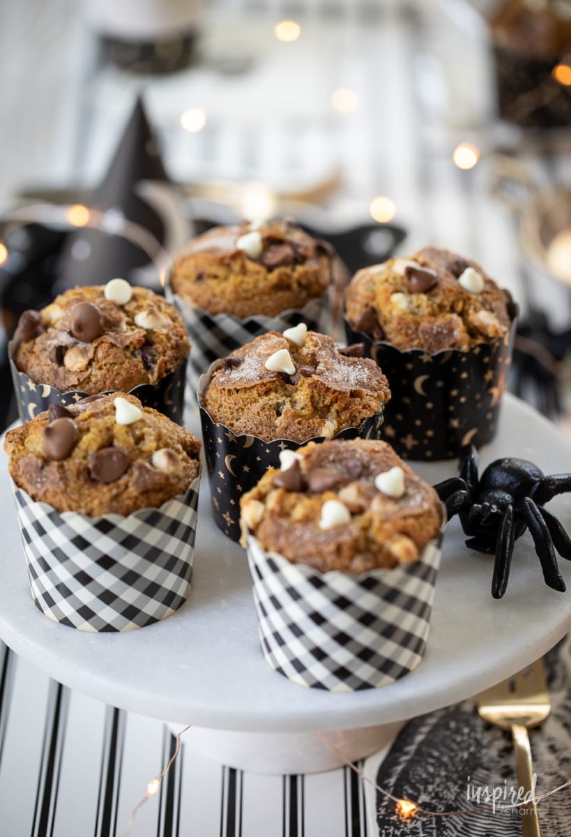 Double Chocolate Chip Pumpkin Muffins on a cake stand.