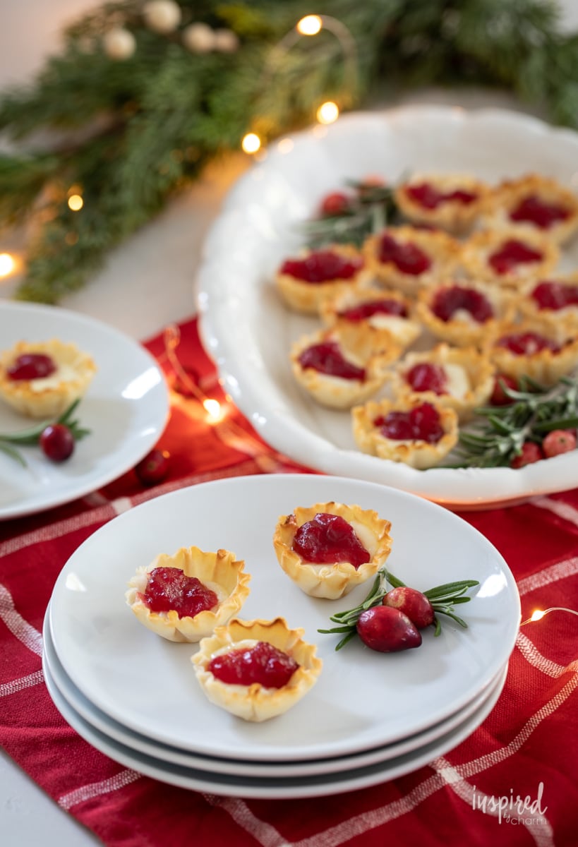 Cranberry Brie Bites on a platter and plates.