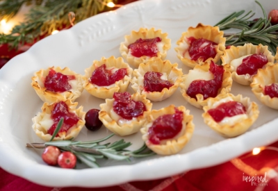 Cranberry Brie Bites on a platter with rosemary.