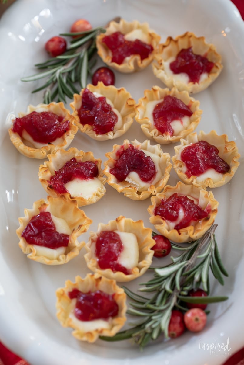 Cranberry Brie Bites on a platter with rosemary.