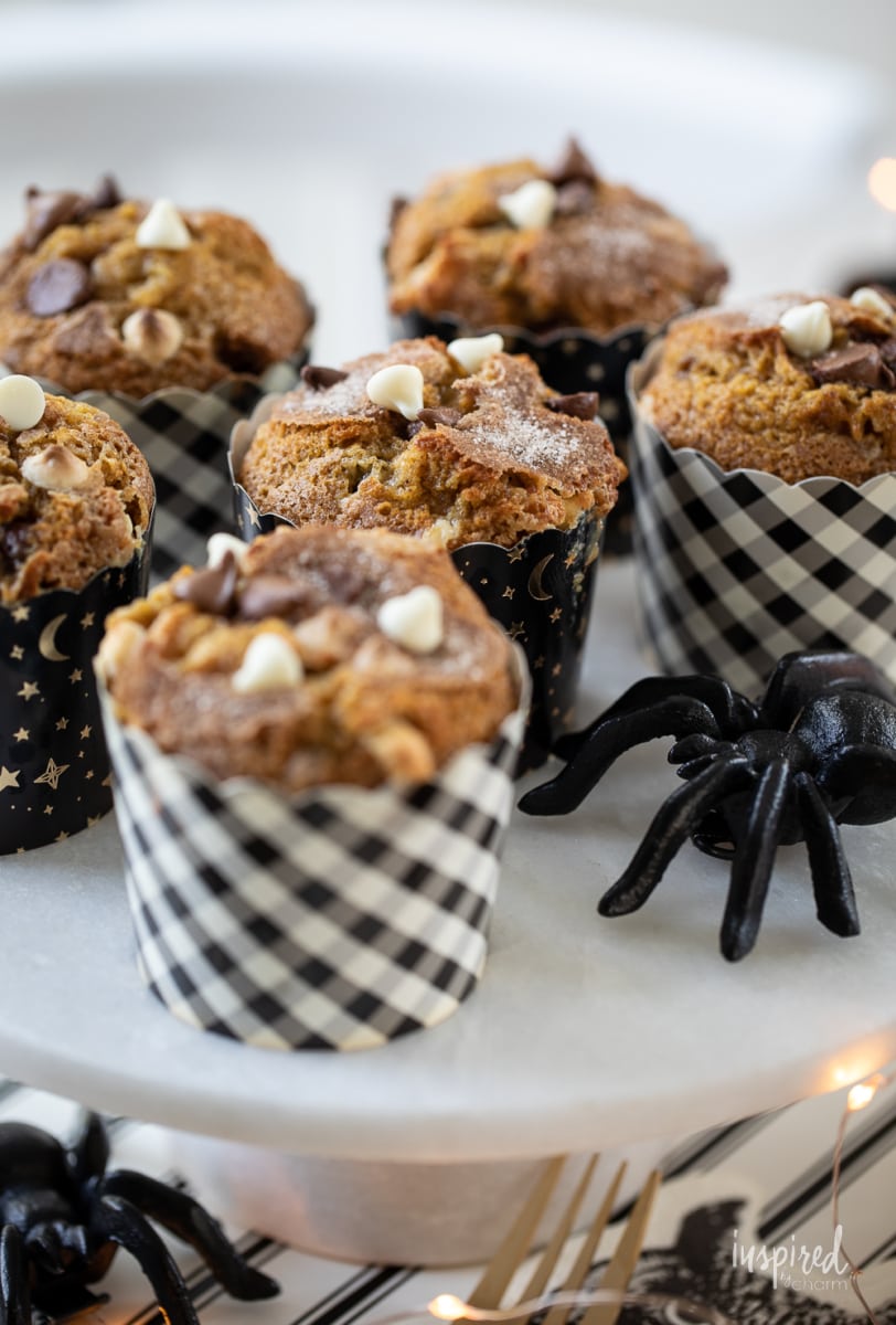Double Chocolate Chip Pumpkin Muffins on a cake stand.