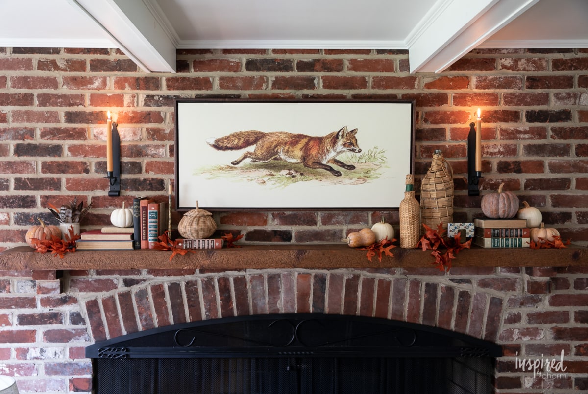 fox painting above mantel on brick wall.
