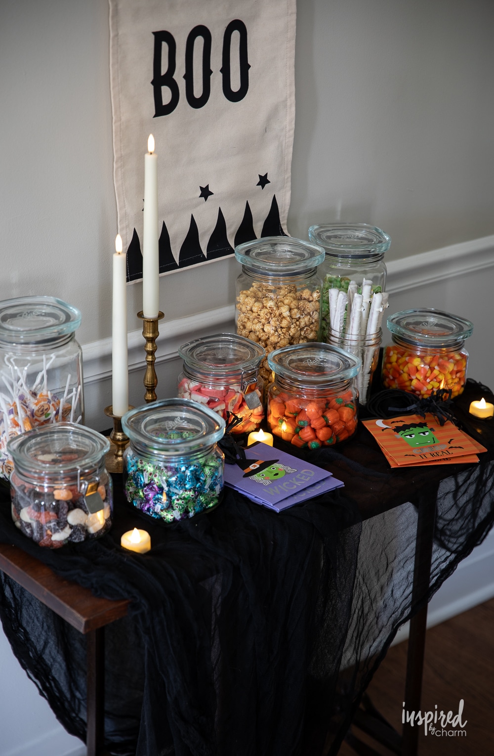 table filled with halloween decorations and candy.