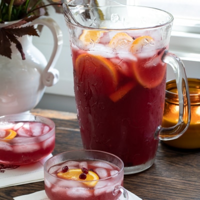 Pomegranate Rum Punch in glasses and pitcher.