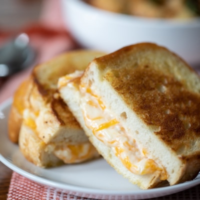 Ultimate Grilled Cheese cut on a plate.