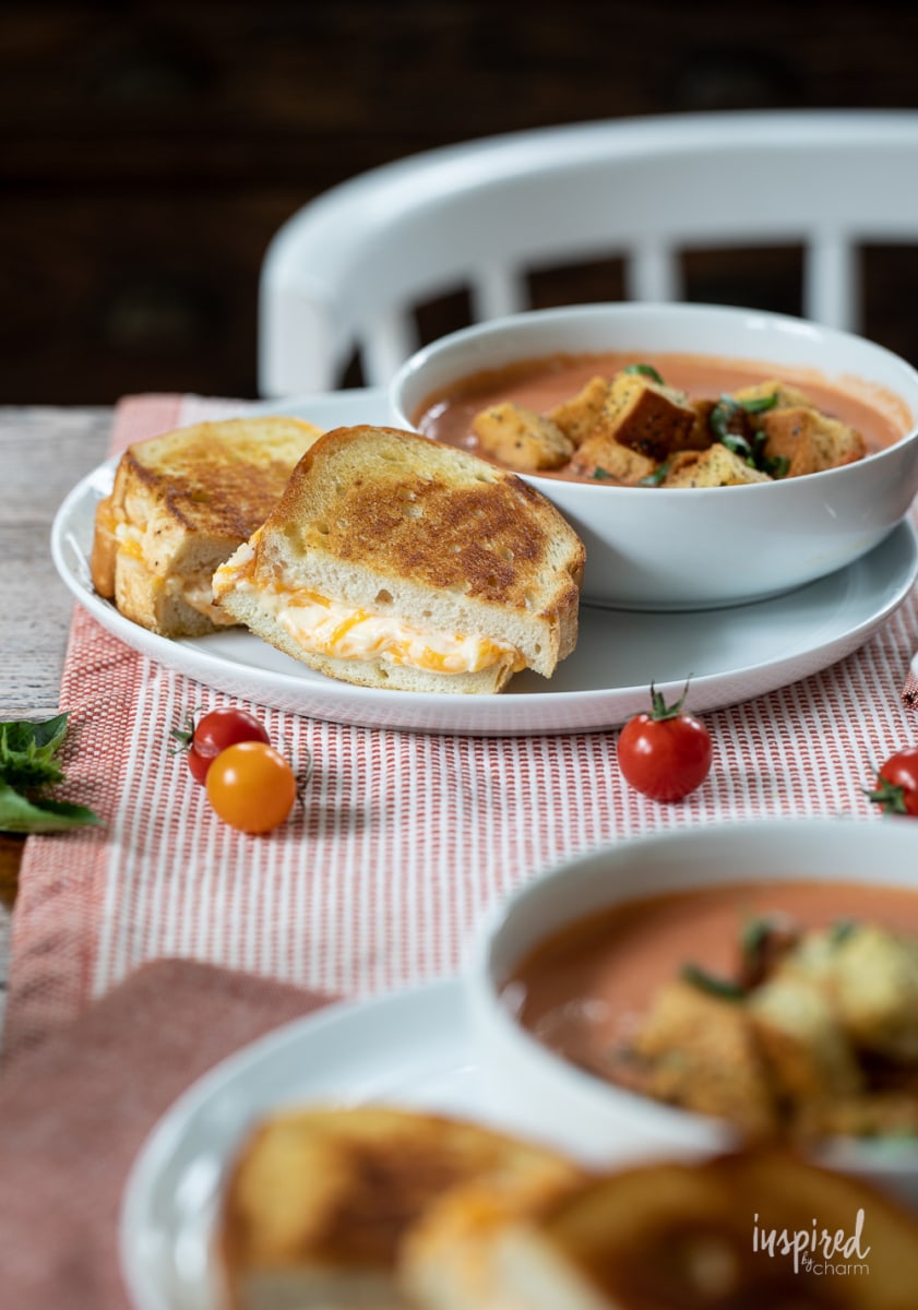 Ultimate Grilled Cheese on plate with tomato soup.