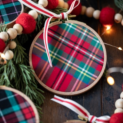 DIY Embroidery Hoop Christmas Ornaments on pine with lights and felt garland.