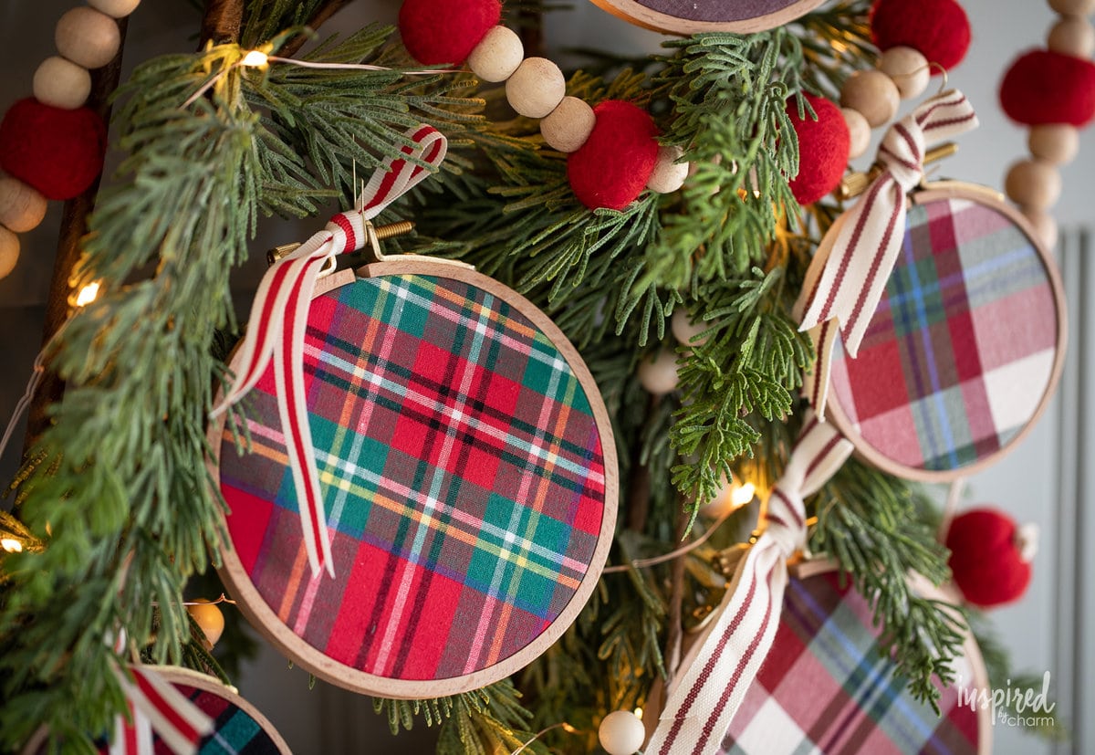 DIY Embroidery Hoop Christmas Ornaments on pine with lights.
