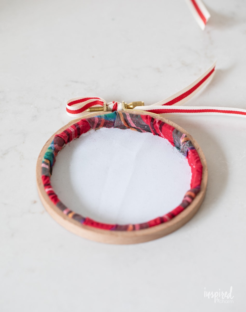 finishing making an embroidery hoop ornament. 