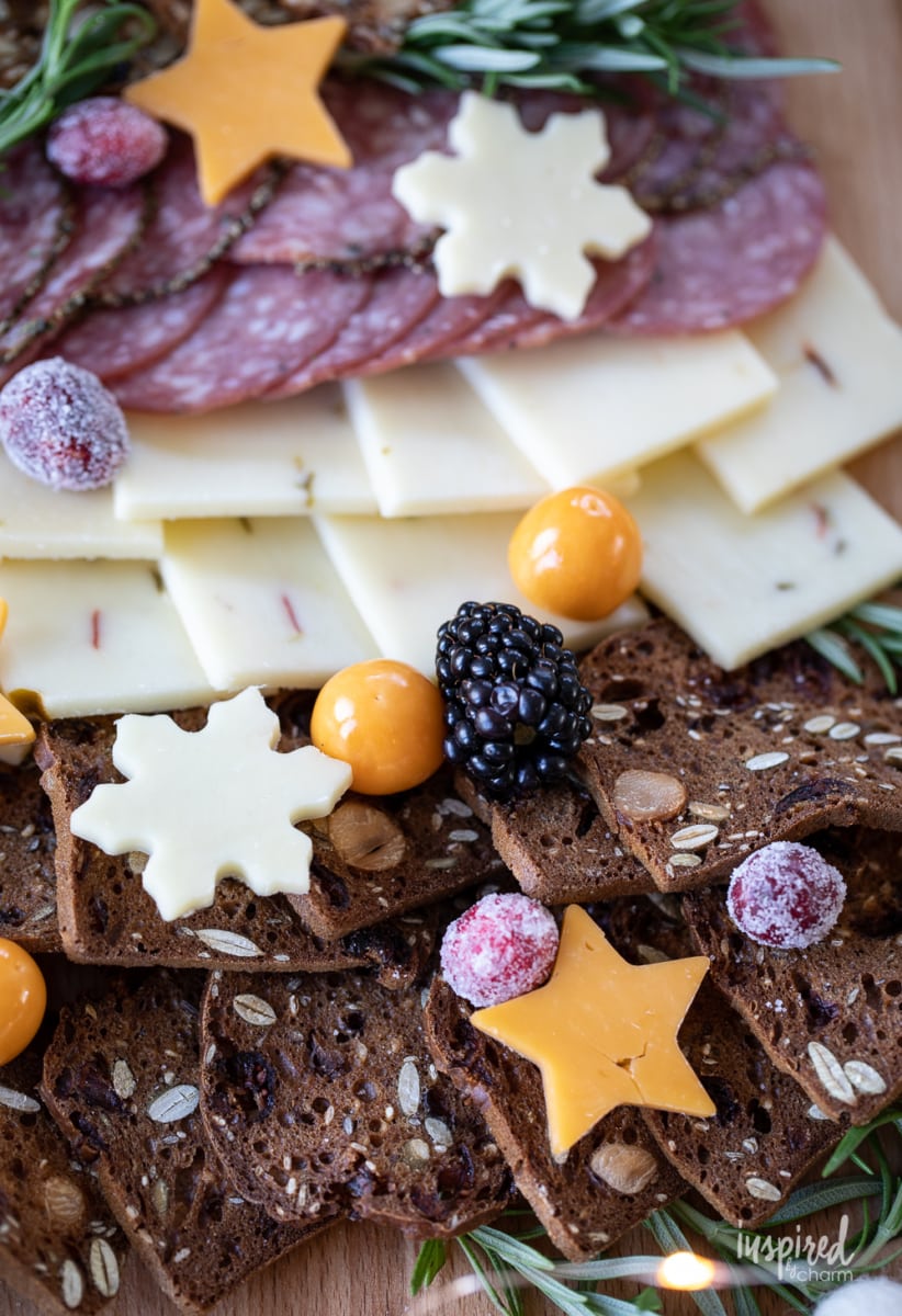 close up of Christmas Cheese Board  shared like a tree on a table. 