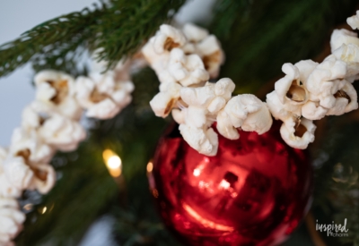 popcorn garland on pine with ornament.