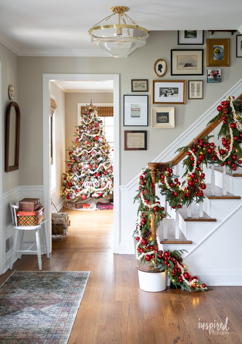 entryway decorate for christmas with popcorn garland on staircase banister.