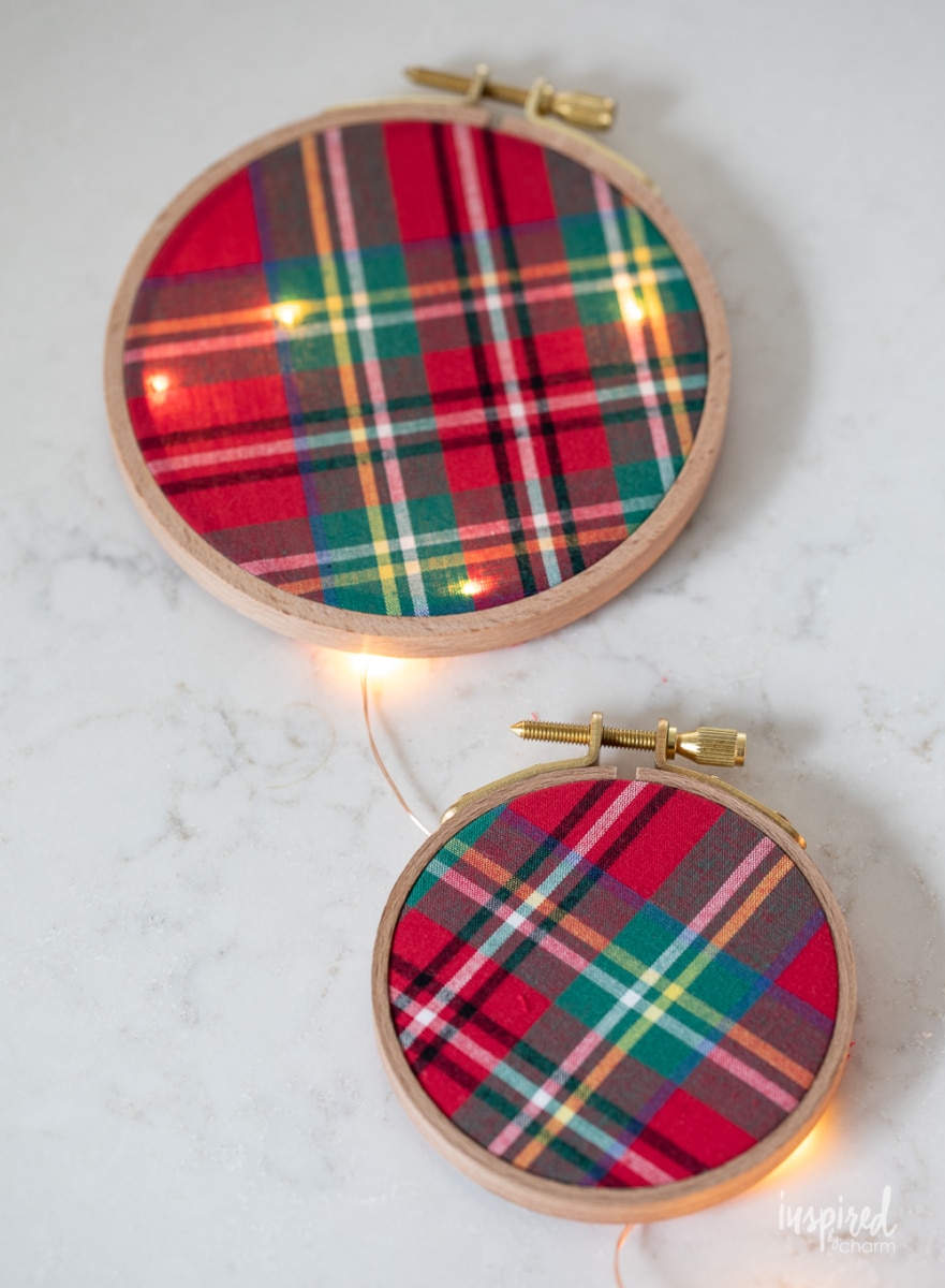 fabric in embroidery hoops with lights behind.