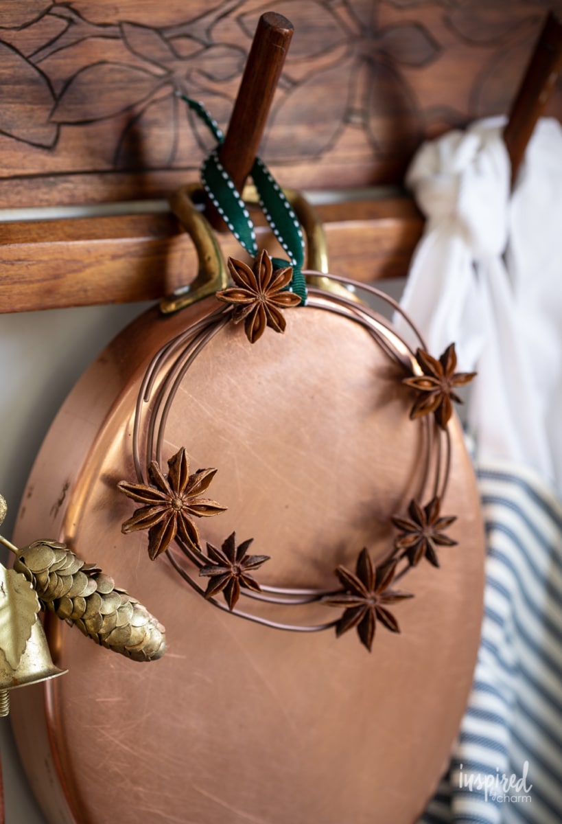 anise wreath hanging on copper pan.