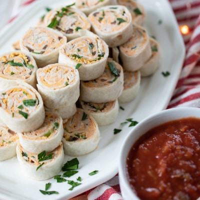 taco pinwheels with salsa on the side.