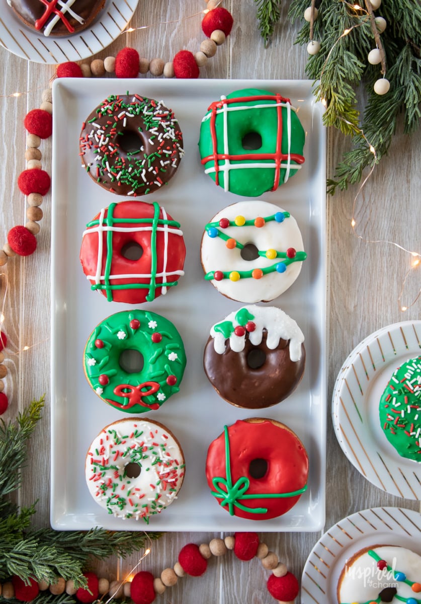 christmas donuts on a platter with a table. 