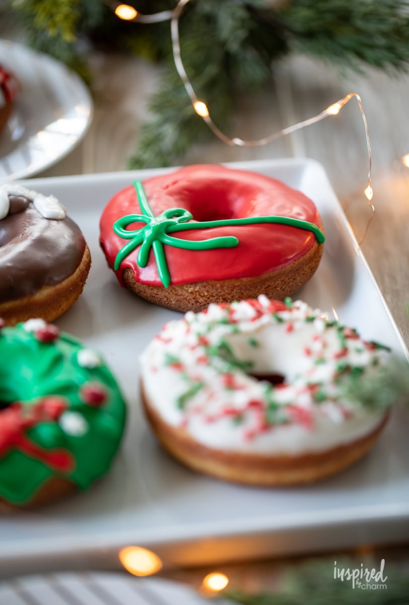 close up of christmas donuts on a platter.