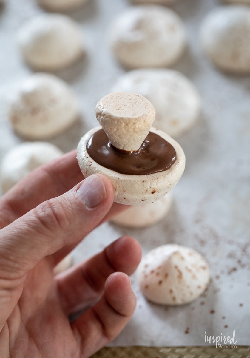 assembling Meringue Mushrooms with chocolate. 