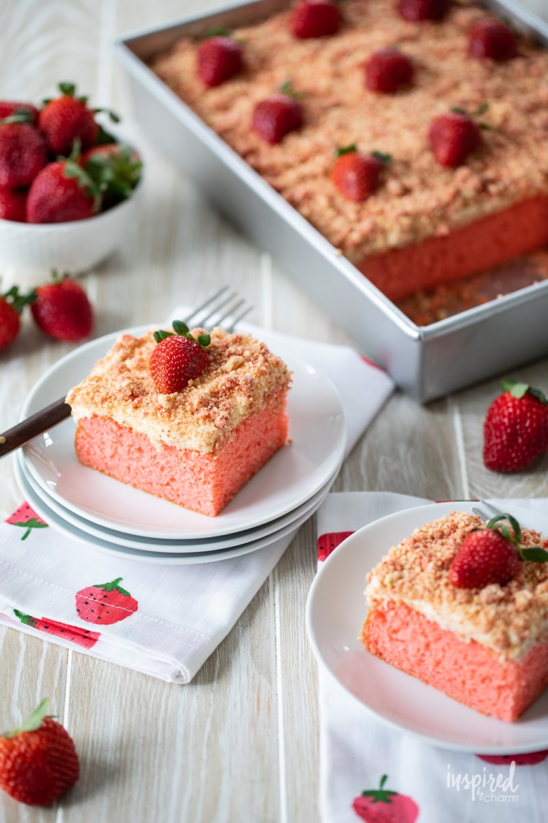 slices of strawberry crunch cake on a plates on a table.