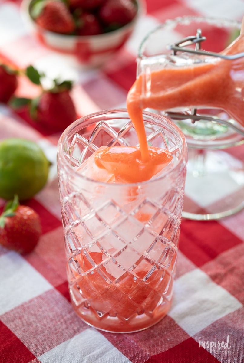 pour strawberry margarita mix into cocktail shaker. 