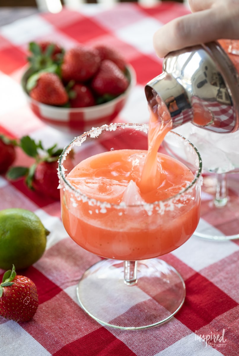 pour strawberry margarita into glass. 